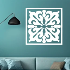 White Moroccan Pinwheel Wall Sticker with a Square Border on a Teal Wall Above a Sofa, Next to a Black Wall Lamp.