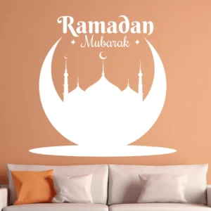 White Ramadan Crescent Wall Sticker on an Orange Wall Above a Beige Sofa, with “ramadan Mubarak” and a Mosque Silhouette Inside a Crescent.