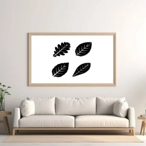 Botanical Leaf Sticker Set Displayed As Black Leaf Silhouettes in Frame Above Neutral Sofa