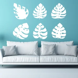 Monstera Leaf Wall Sticker Set (6 Pieces) in White on Light Blue Wall Above Modern White Sofa