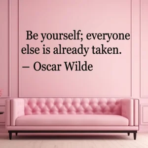 Pink Paneled Wall Above a Blush Tufted Sofa; Black Wall Quote “be Yourself; Everyone else is Already Taken.” – Oscar Wilde.