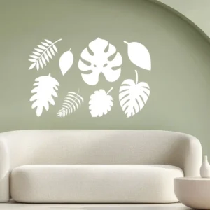 Tropical Leaf Set (8 Pieces) White Tropical Leaf Wall Decals Arranged Above a Curved Beige Sofa on a Sage Green Wall