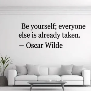 White Wall Above a White Sofa with Black Serif Quote “be Yourself; Everyone else is Already Taken.” – Oscar Wilde.
