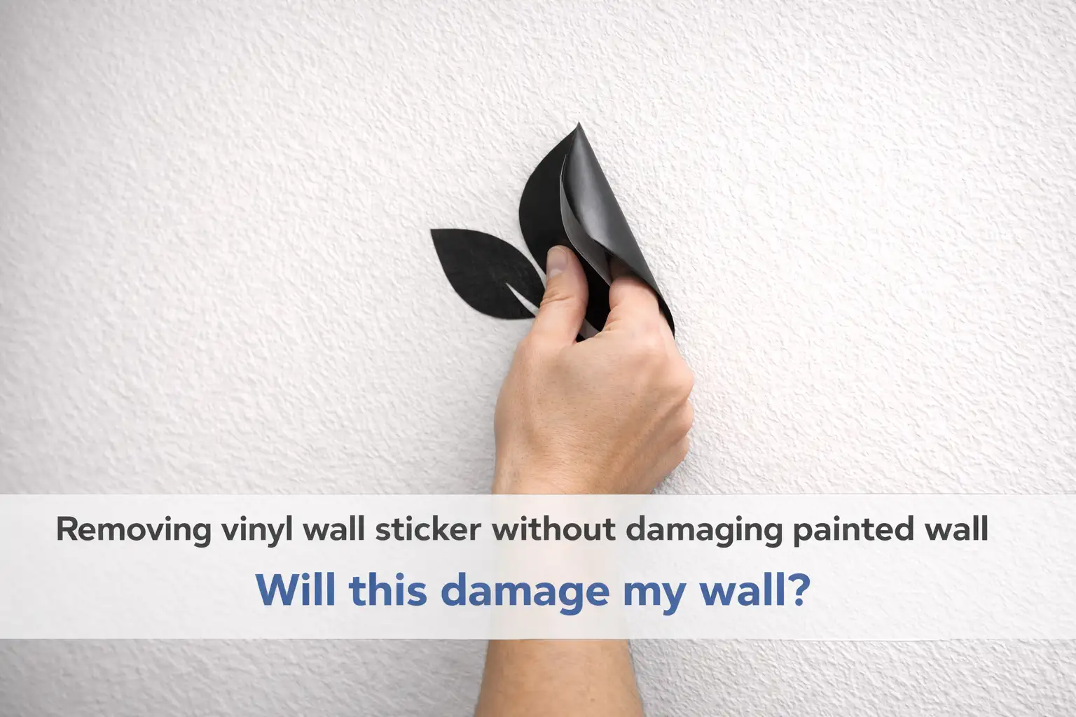 Hand peeling a black vinyl leaf sticker off a white textured wall; banner text reads 'Removing vinyl wall sticker without damaging painted wall'.